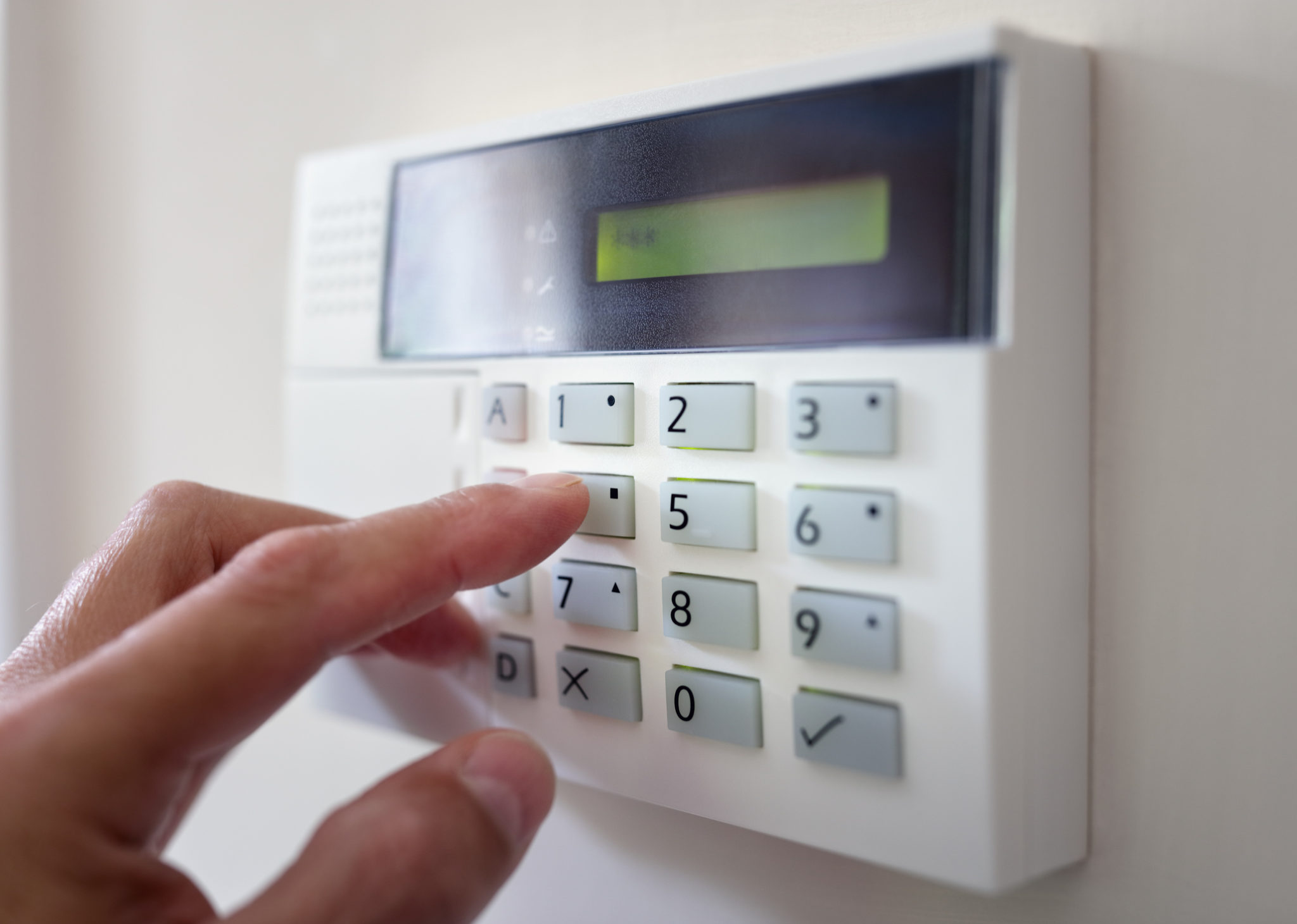 Security alarm keypad with person arming the system concept for crime prevention